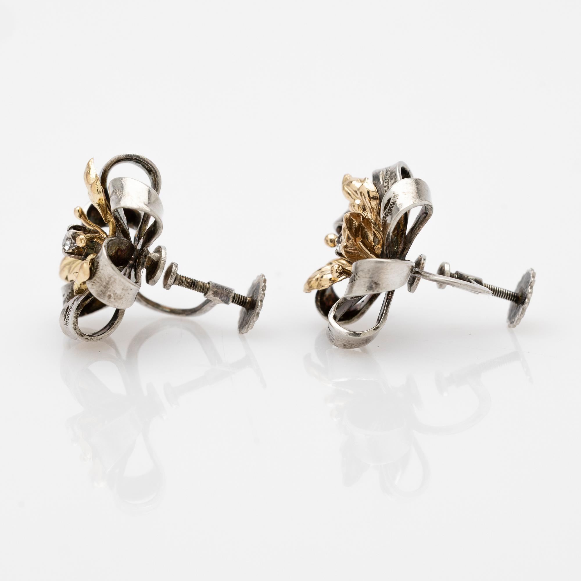 Earrings, a pair, silver and 14k gold with brilliant-cut diamond.