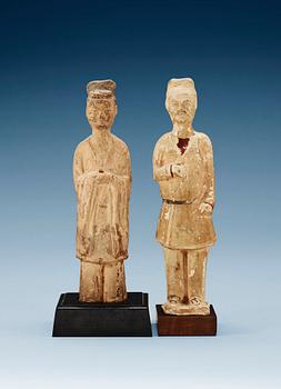 1624. Two glazed pottery figurines of standing officials, with traces of paint, Tang dynasty (618-907).