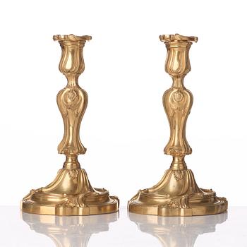 A pair of French Louis XV mid 18th century gilt bronze candlesticks.