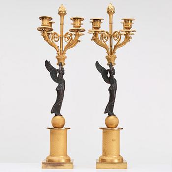 A pair of Empire four light candelabra.