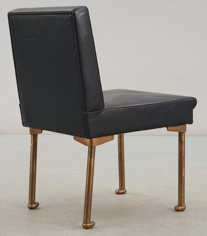 An Alvar Aalto bronze and black leather chair, Artek, Finland 1954.