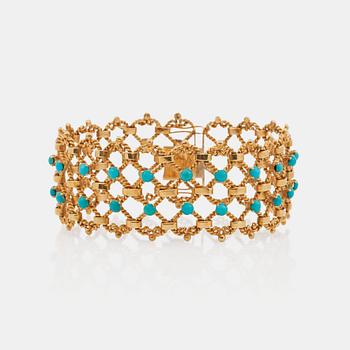 A gold and turquoise bracelet.