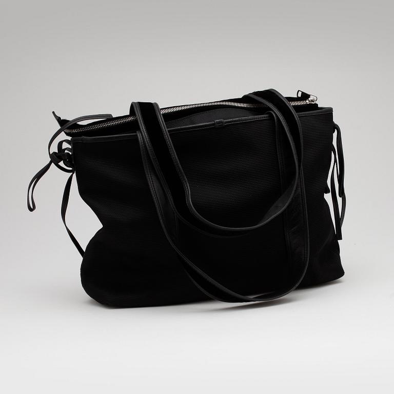 YVES SAINT LAURENT, a black fabric tote with leather details.