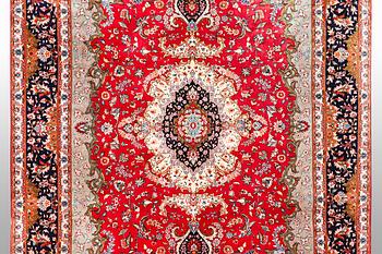 A carpet, Tabriz part silk, 60 Raj, ca 357 x 248 cm.