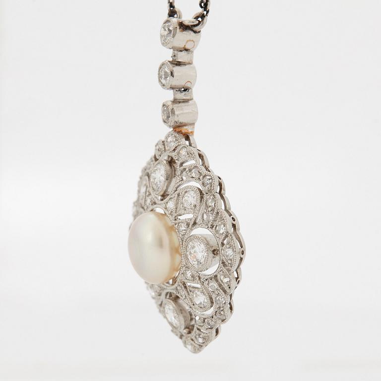 A platinum pendant set with a bouton pearl and old- and rose-cut diamonds.