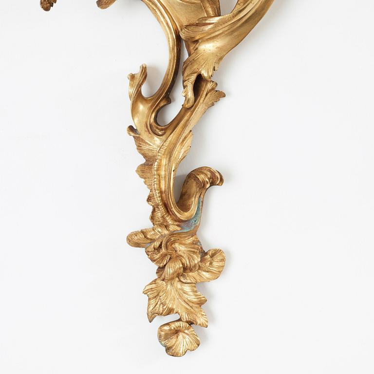 A pair of Louis XV mid 18th century three-light wall-lights.