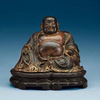 A lacquered bronze figure of Budai, Qing dynasty (1644-1912).