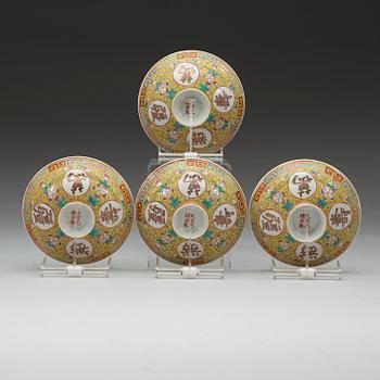 A set of four yellow ground famille rose bowls with covers, early 20th century with Guangxu six character mark in red.