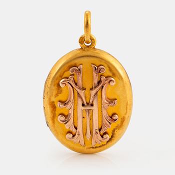 A 14K gold and rose gold locket with monogram MH in relief.