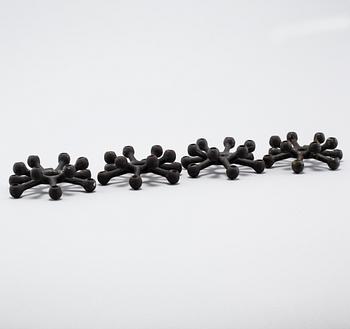 Four 1960s iron cast candle holders, designed by Jens Quistgaard for Dansk Designs .