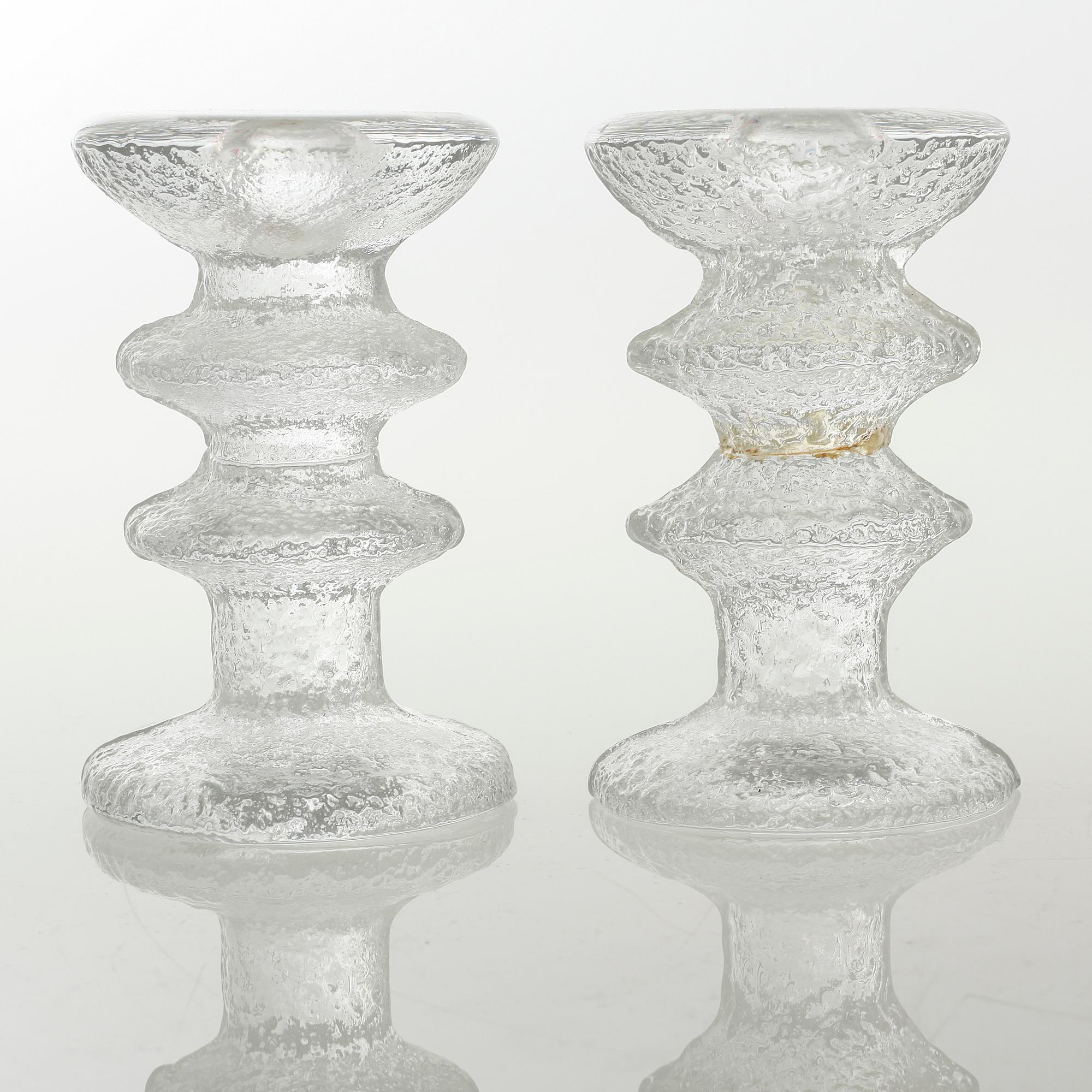 Five glass candlesticks by Timo Sarpaneva for Iittala, model "Festivo", second half of the 20th century.