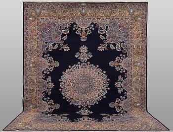A Kerman Laver carpet, signed, approx. 436 x 280 cm.