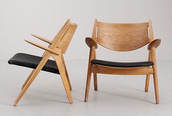 A pair of Hans Wegner easy chairs by Carl Hansen, Denmark, 1950's.