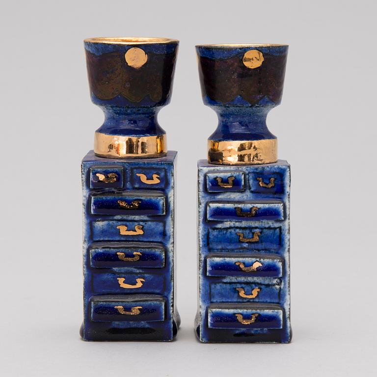 A pair of ceramic candlesticks signed Kaipiainen.