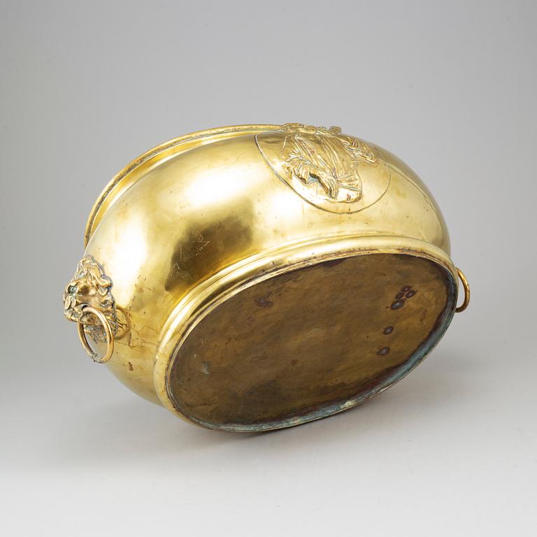 A 19th century brass champagne cooler.