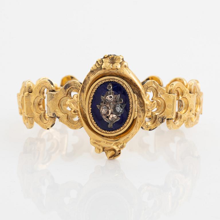 An 18K gold and blue enamel bracelet.