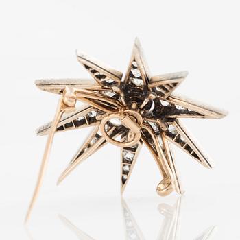 Brooch/pendant, in the shape of a star, silver and gold with old-cut diamonds.