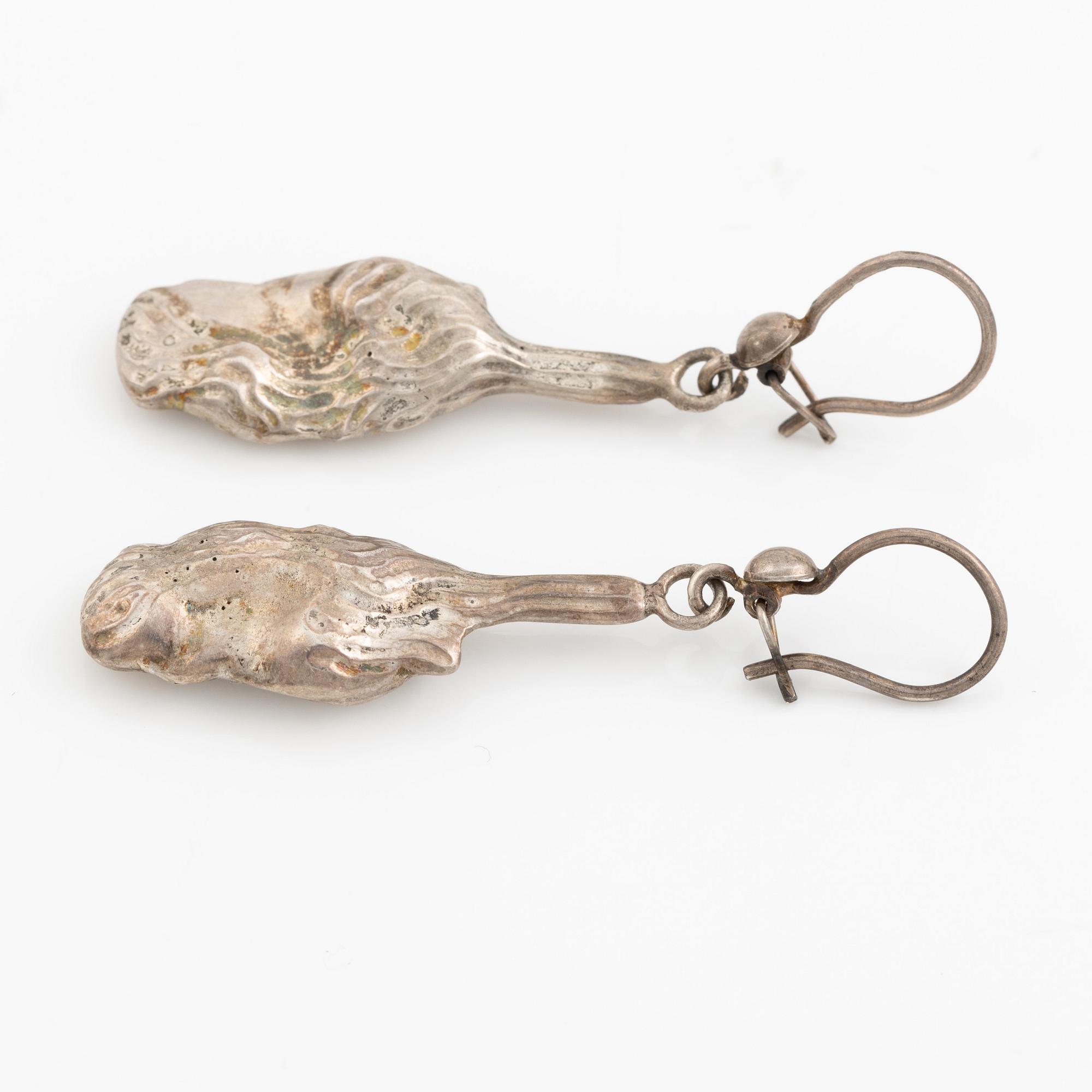 A pair of silver earrings, likely Olle Ohlsson.