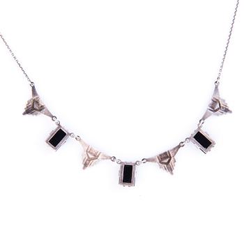 Four Art deco jewelry, ring, pendant necklace and earrings in silver.