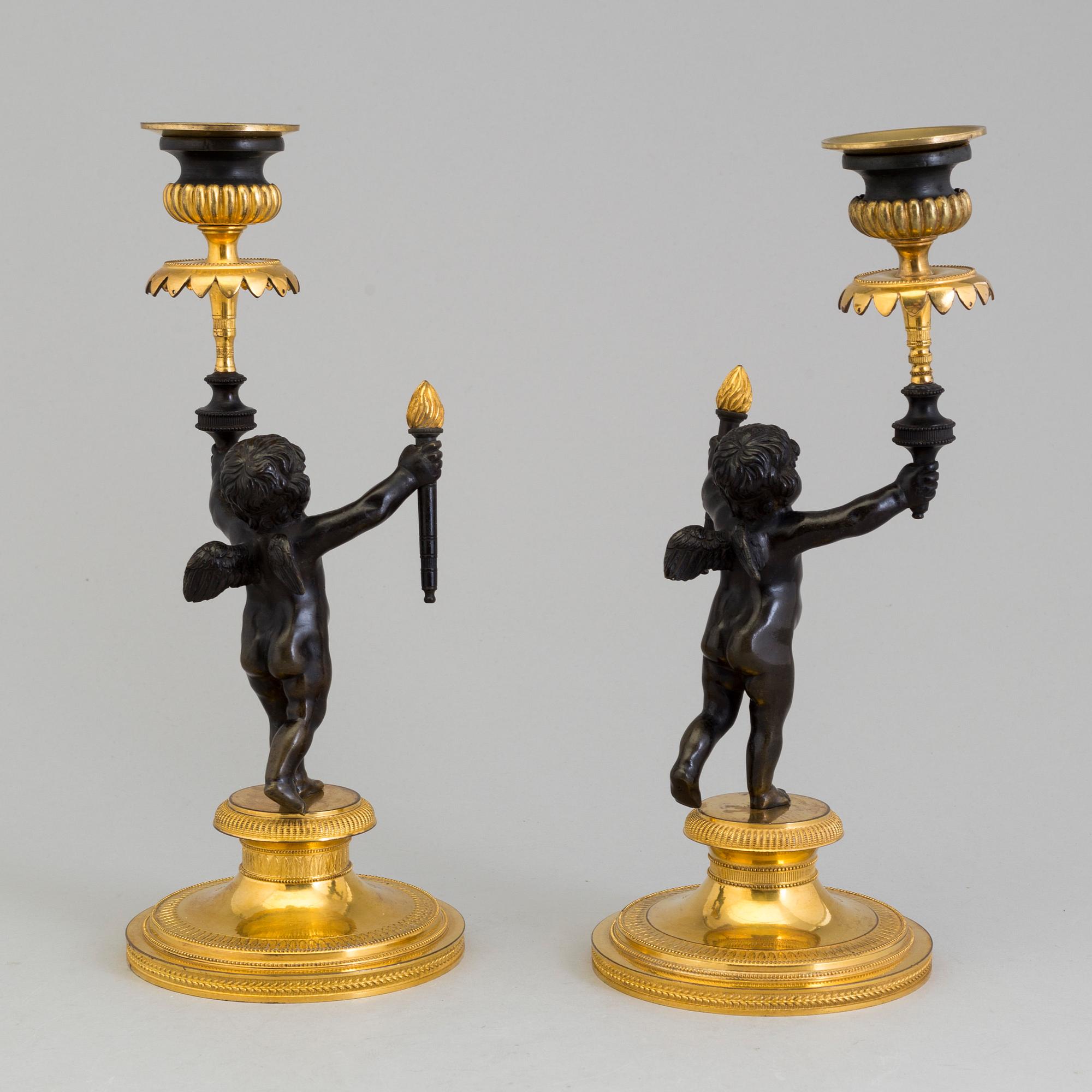 A pair of late 19th century, gilded bronze, Empire style, candle sticks.