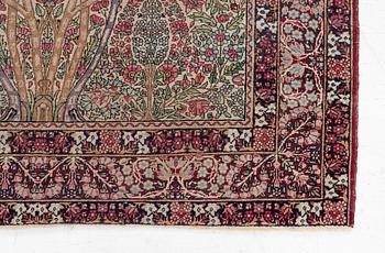 An antique Kirman rug, south Persia, c. 220 x 140 cm.