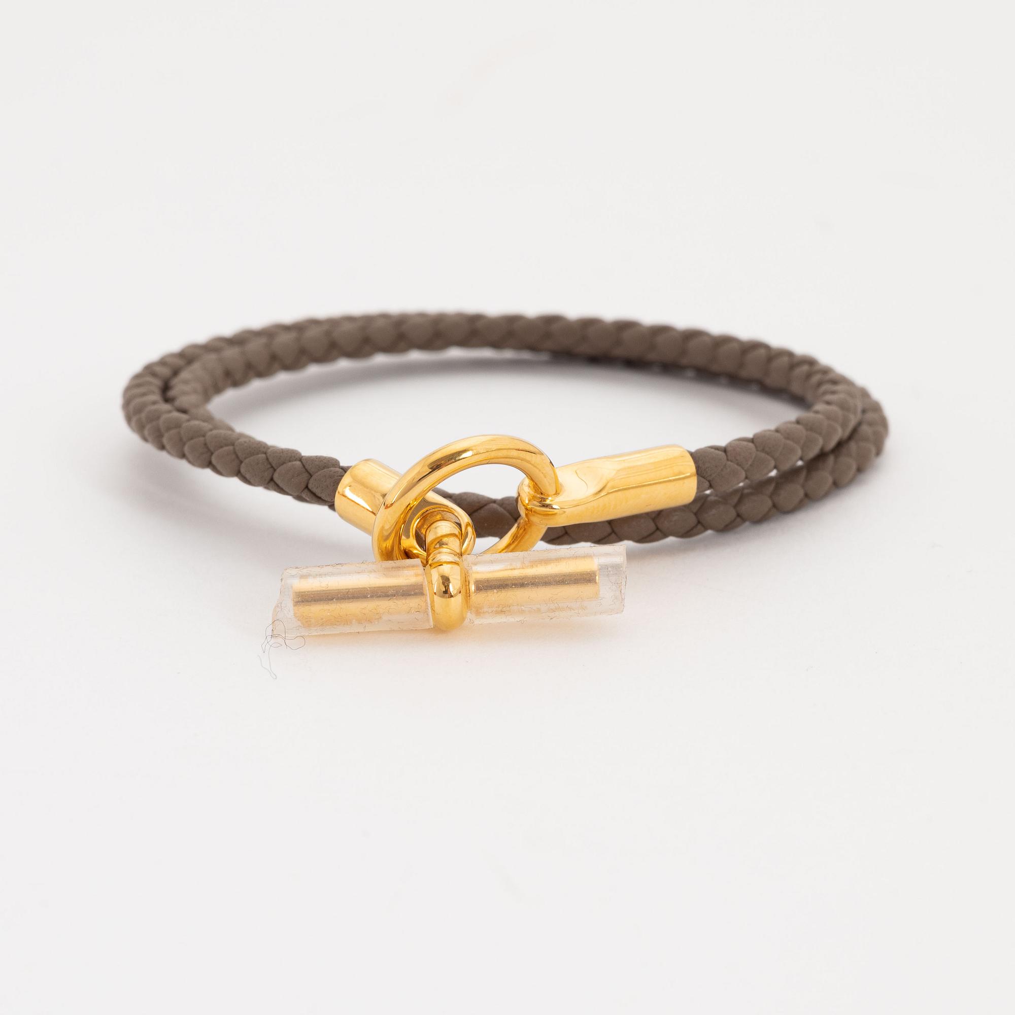 Hermès, a leather bracelet and key chain.