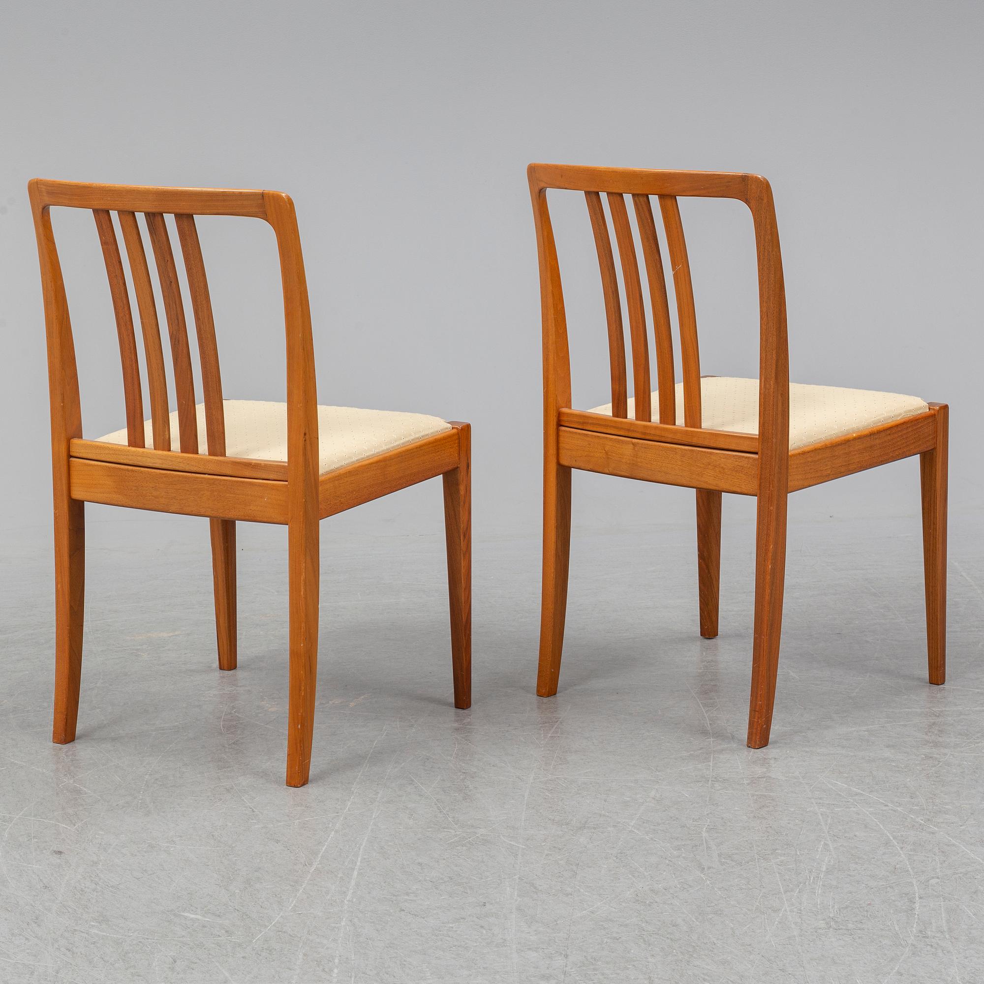 A 1950/60s teak and valnut table and four chairs.