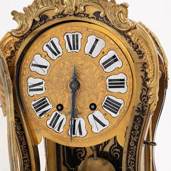 A 19th century rococo style clock, and a 18th century rococo console.