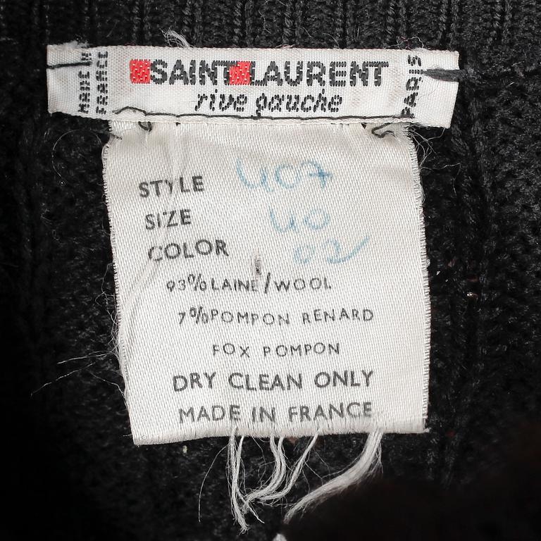 YVES SAINT LAURENT, a black cardigan with brown fox fur trimming.
