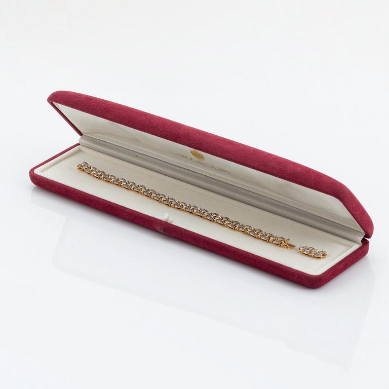 An 18K gold and white gold bracelet set with round brilliant-cut diamonds.