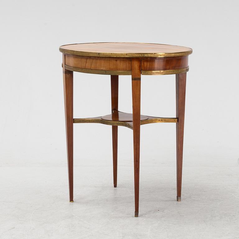 A mahogany veneered Louis XVI style table, 19th Century.