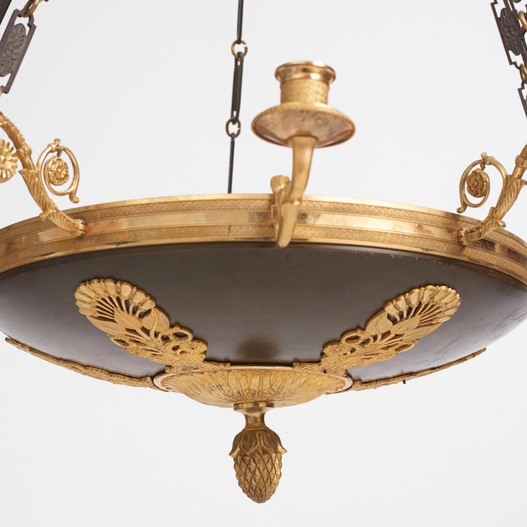 An Empire.style five-branch patinated and gilt bronze chandelier, later part of the 19th century.