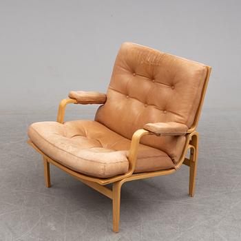 BRUNO MATHSSON, a pair of easy chairs with one stool.