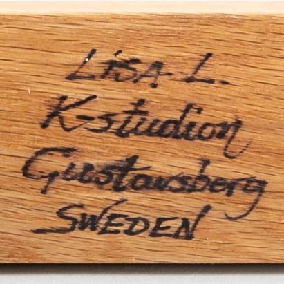 LISA LARSON, a signed candlestick.