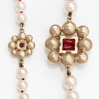 Chanel, A pearl collier with plastic pearls, glass stones and gold coloured metal parts. Marked Chanel, Made in France.