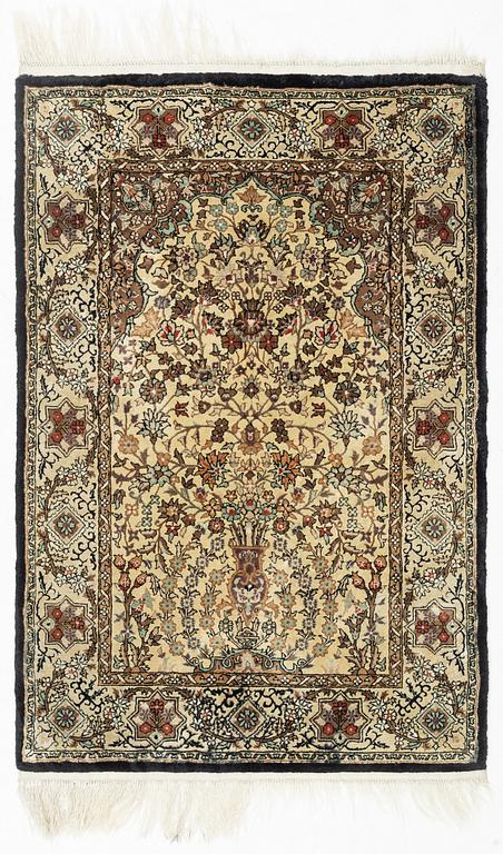 An oriental silk rug, c. 93 x 63 cm.