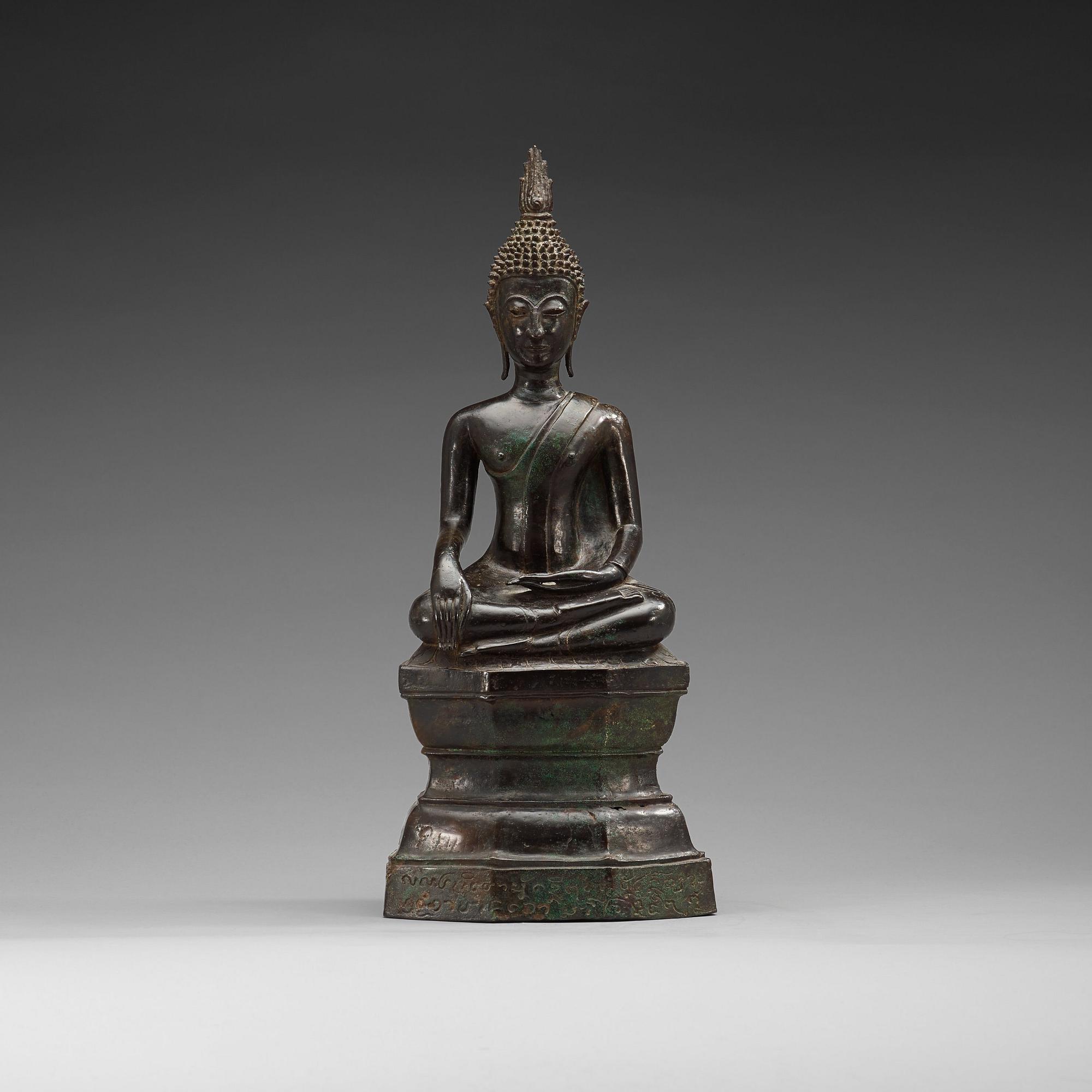 A large seated bronze figure of buddha, Thailand, 19th Century or older. With inscription to base.