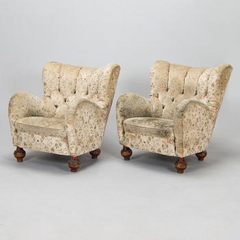 A pair of mid-20th-century armchairs.