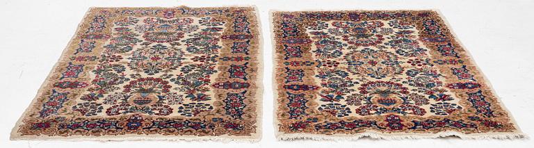 A pair of similar Kirman rugs, south Persia, c. 147 x 94 and 154 x 96 cm.