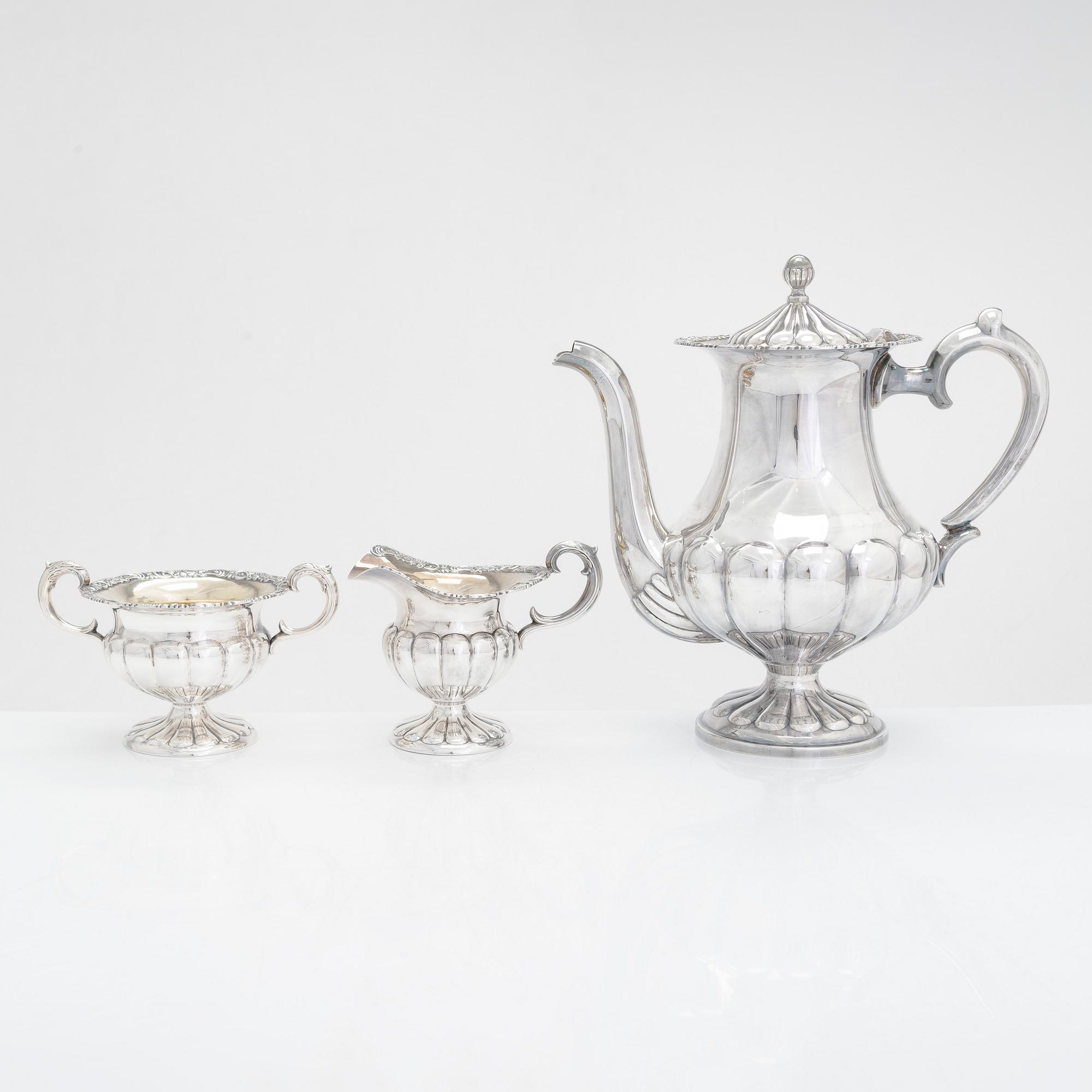 Silver sugar tongs, Herman Wist, Uusikirkko, Carelia 1928, a 3-piece coffee service, a candlestick pair, Finland 1950s.