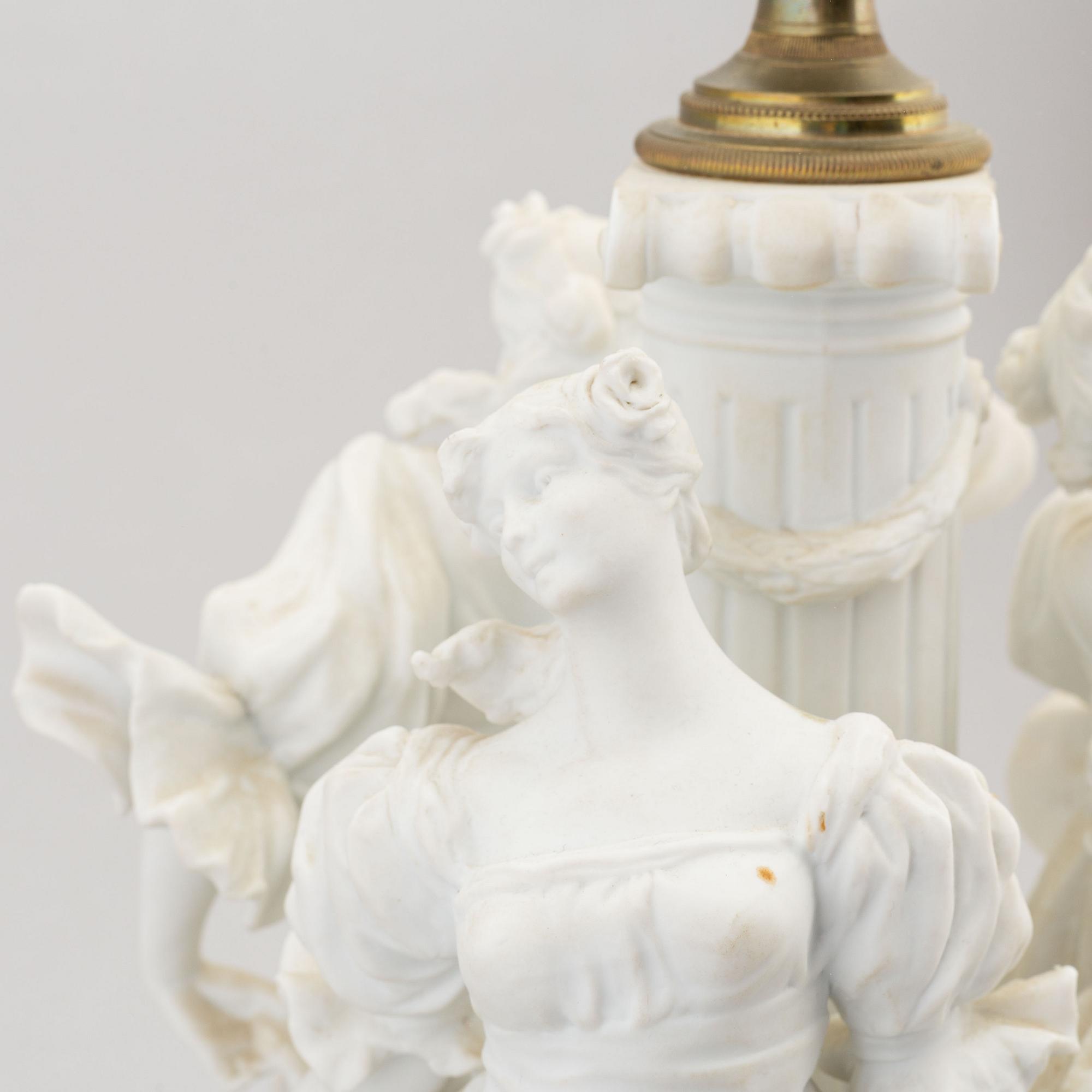 A parian and metall table lamp, first half of the 20th century.