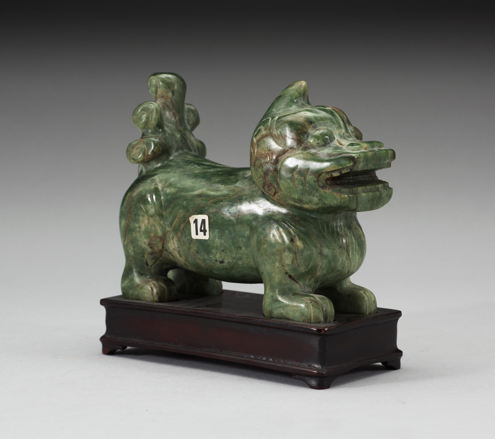 A nephrite figure of a Buddhist Lion, late Qing dynasty.