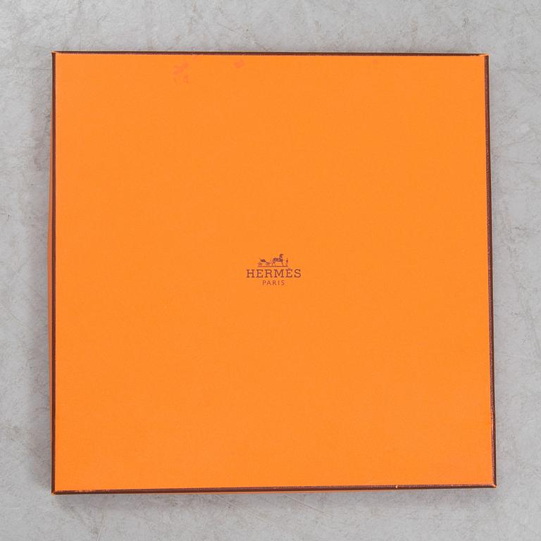 a "Dancing pearls" silk scarf by Hermès.