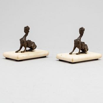 A pair of bronze sculptures on marble plinths, ca 1900.