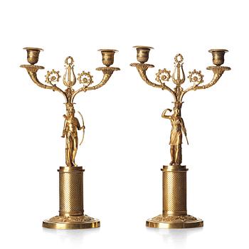 A pair of French Empire two-light gilt bronze candelabra, early 19th century.