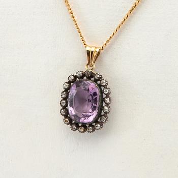 Pendant, 18k gold with diamonds and purple stone.