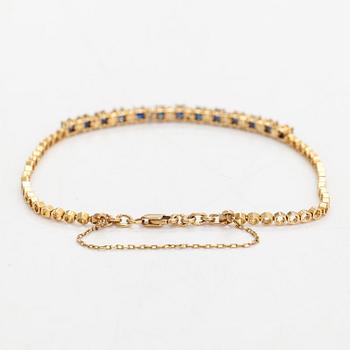 Rannkoru, 14K kultaa, timantteja n. 0.12 ct yht ja safiireja.