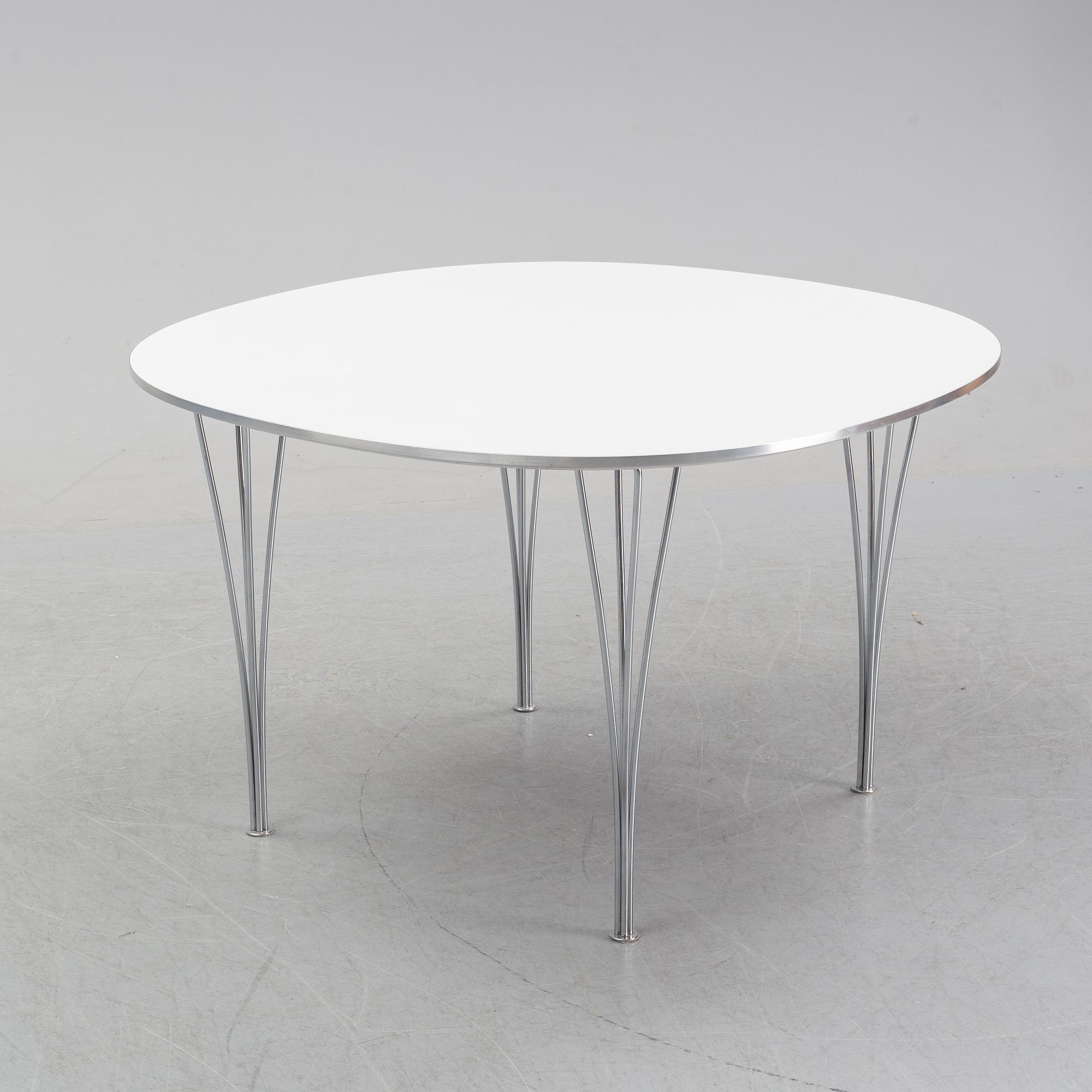 A 'Supercircular' table by Bruno Mathsson & Piet Hein for Fritz Hansen, dated 1985.