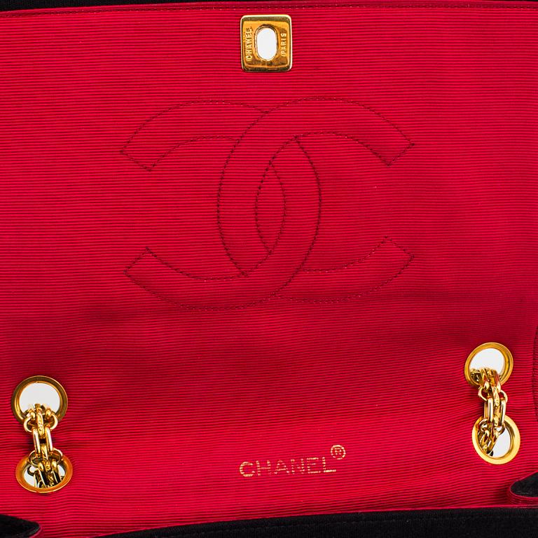 A black quiltet jersey handbag by Chanel.