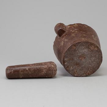 A lime stone pistil and mortar, 19th Century.